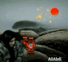 a picture of a woman sleeping with a red lantern and the name aliabdi on the bottom