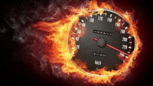 a speedometer surrounded by flames and smoke on a black background .