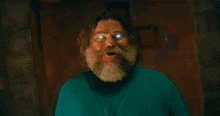 a man with a beard has glowing eyes and a green sweater