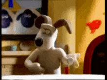 a cartoon dog is standing in front of a tv in a room