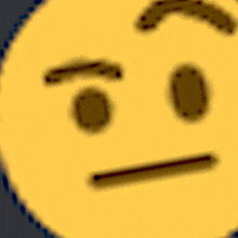 a blurred image of a yellow face with a serious expression