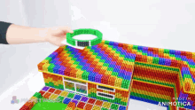 a colorful house made out of magnets with the words made in animatica on the bottom right