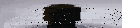 a black lego man is standing in the dark with a white background .