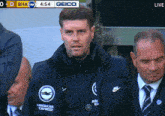 a man in a jacket that says american express on it
