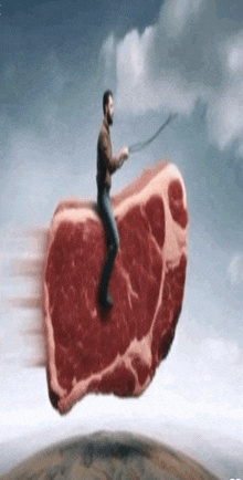 a man is riding a large piece of meat