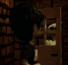 a woman is looking at a stuffed animal in a cage .