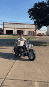 a man is sitting on a harley davidson motorcycle in front of a building