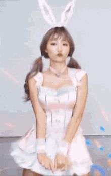 a woman in a pink dress with bunny ears