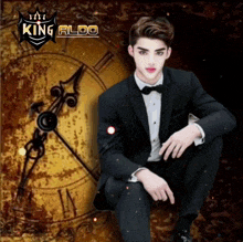a man in a tuxedo sits in front of a clock with king aldo written on it