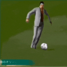 a man in a suit is kicking a soccer ball .