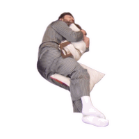 a man in striped pajamas is sleeping on a white pillow