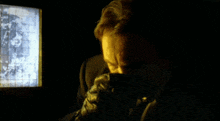 a man in a suit looks at a screen with a map on it