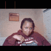 a woman wearing a hoodie that says noir steaming