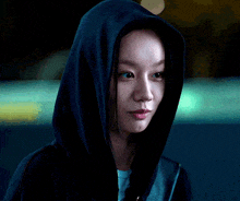 a close up of a woman wearing a hooded sweatshirt