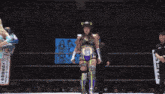 a woman in a wrestling ring holds a belt that says ' slive ' on it