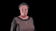 a woman in a black and tan dress is clapping