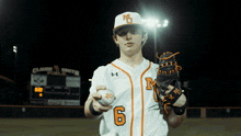 a baseball player with the number 6 on his jersey holds a ball