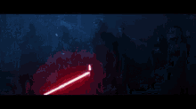 a group of soldiers are standing in a dark room holding lightsabers