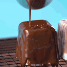 chocolate is being poured on a piece of cake that says mr cakes