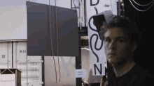 a man is standing in front of a sign that says work space