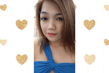 a woman in a blue dress with gold hearts around her