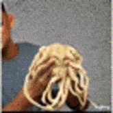 a person is holding a rope in their hands and looking at it .