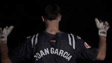 a man wearing a jersey with the name joan garcia on the back