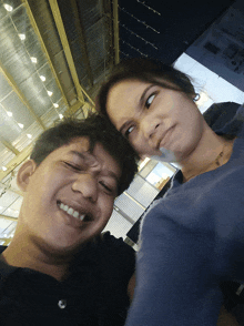 a man and a woman are posing for a picture