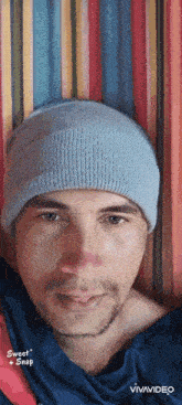 a man wearing a beanie is laying in a hammock with the words sweet snap on the bottom