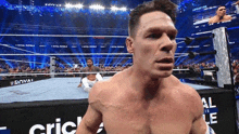 a man in a wrestling ring with a sign that says ' royal rumble ' on it
