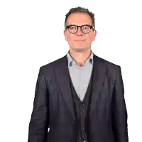 a man wearing glasses and a suit makes a surprised face