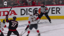 a hockey game is being played in front of a honda ad