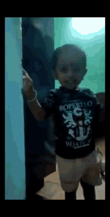 a young boy wearing a black shirt that says property of boating