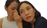 a woman whispering a secret into another woman 's ear