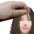 a hand is touching a woman 's forehead in a pixel art .
