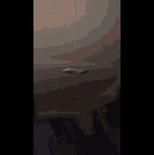 a man with a beard is standing in a dark room .