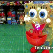 a spongebob doll is standing on a green cutting board
