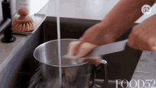 Washing Knife Food52 GIF - Washing Knife Food52 Cleaning A Knife GIFs