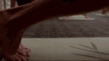 a close up of a person 's leg on a mat