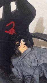 a stuffed animal wearing headphones and sunglasses is laying in a chair