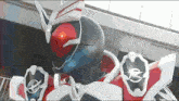 a close up of a masked rider 's helmet with a red eye