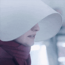 a close up of a woman wearing a white hat