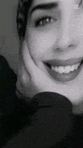 a close up of a woman 's face with her hand on her face