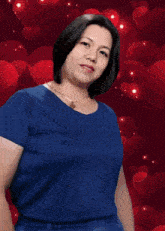 a woman in a blue shirt is surrounded by hearts and sparkles
