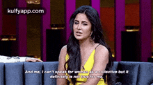a woman in a yellow dress is sitting on a couch .
