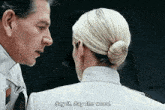 a man and a woman are looking at each other and the woman says " say it say the word "