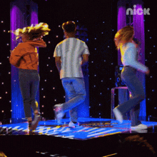 a group of people are dancing on a stage with the nick logo in the corner