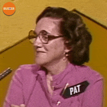 a woman in a purple shirt has a name tag that says pat
