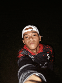 a young man taking a selfie wearing a shirt that says ep on it