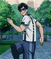 a man in a white shirt and blue pants is standing on one leg in a park .